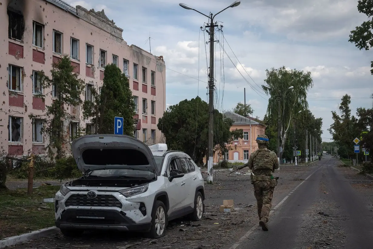 A Ukrainian soldier walks past at a city hall in Sudzha, Kursk region, Russia, Friday, August 16. This image was approved by the Ukrainian Defense Ministry before publication.