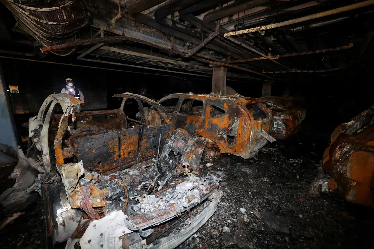 FILE PHOTO: Vehicles that were completely burned down due to a Mercedes Benz electric car fire that broke out on August 1st, are lying in the underground parking lot of an apartment complex in Incheon