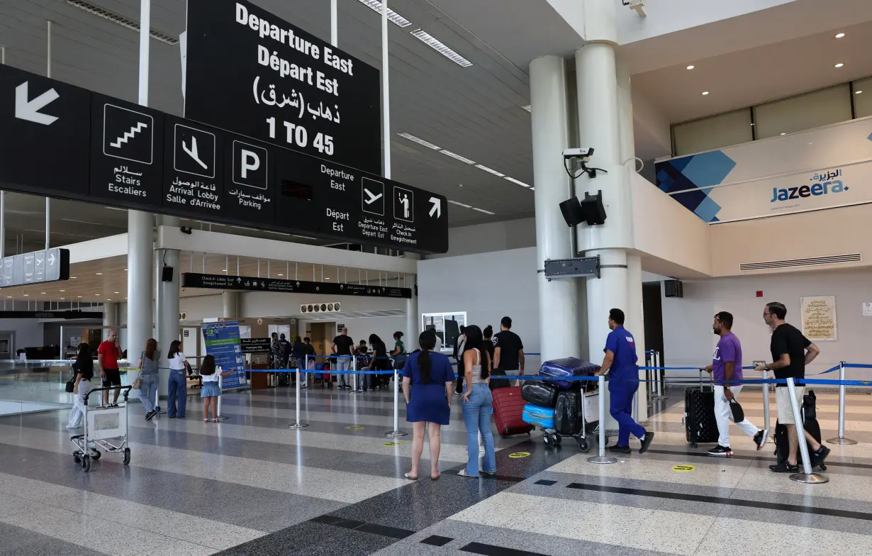 People push luggage at Beirut-Rafic Hariri International Airport