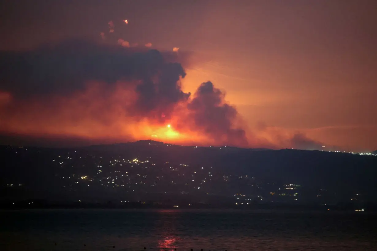 A view shows smoke and fire on the Lebanese side of the border with Israel, after Israel said it carried out strikes on Hezbollah targets in Lebanon, as seen from Tyre, southern Lebanon, on August 25.