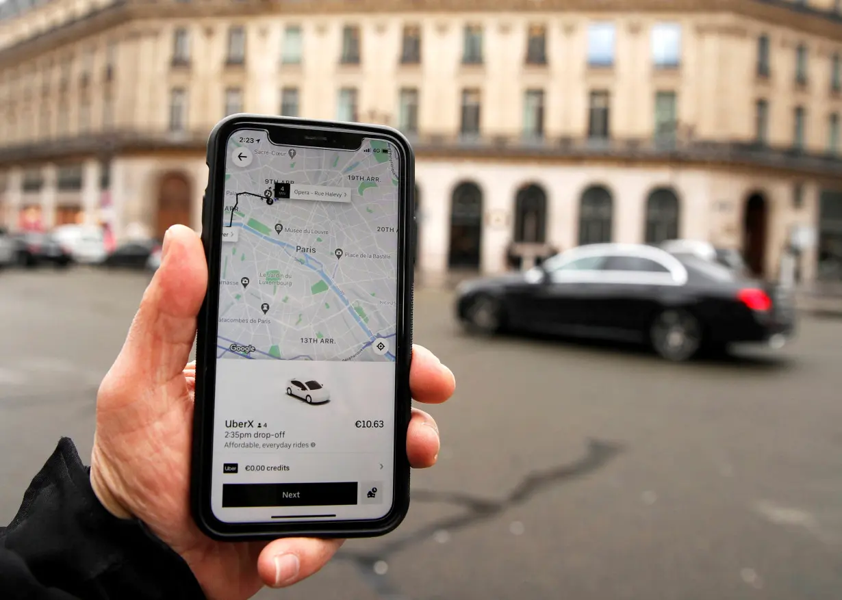 FILE PHOTO: A photo Illustration shows the Uber application on a mobile phone in in central Paris