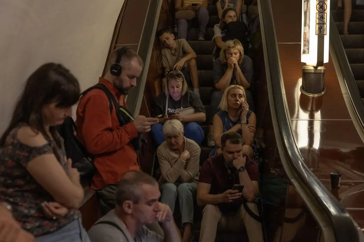 People take shelter in the Tealtralna metro station in Kyiv, Ukraine, August 26, 2024.