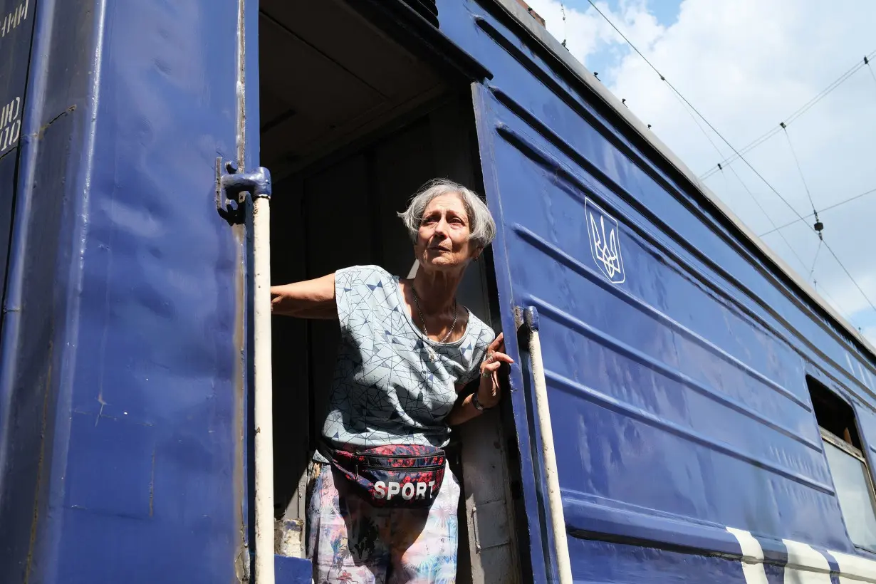 A woman from the Pokrovsk area boards an evacuation train amid continuing Russian advances toward the city.