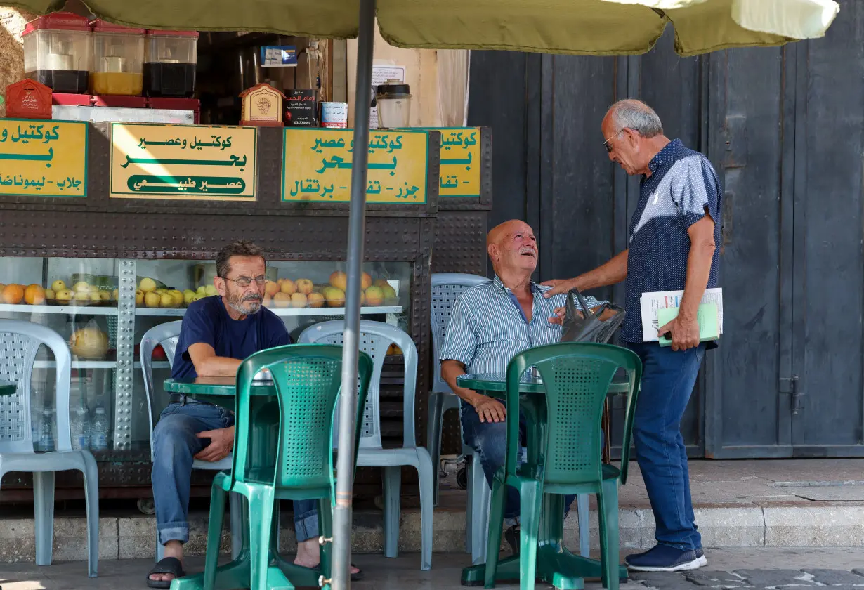 Resident sits at juice stand in Tyre