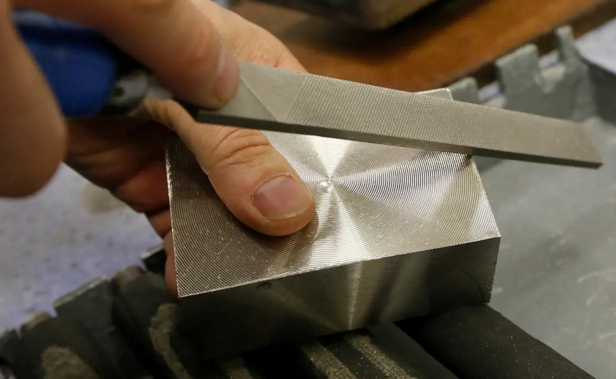 FILE PHOTO: An employee works on an ingot of 99.97 percent pure palladium at the Krastsvetmet nonferrous metal plant in Krasnoyarsk