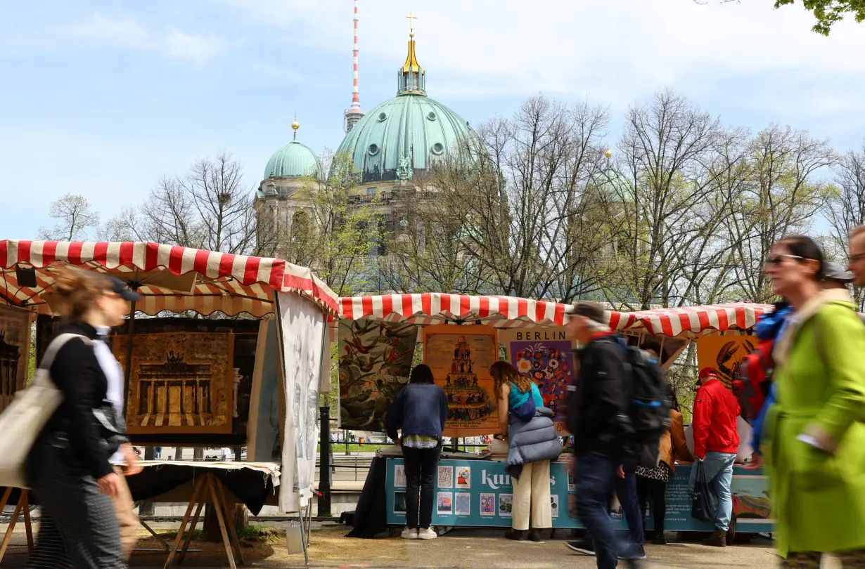 People visit the Berlin Art Market by the Zeughaus building in Berlin