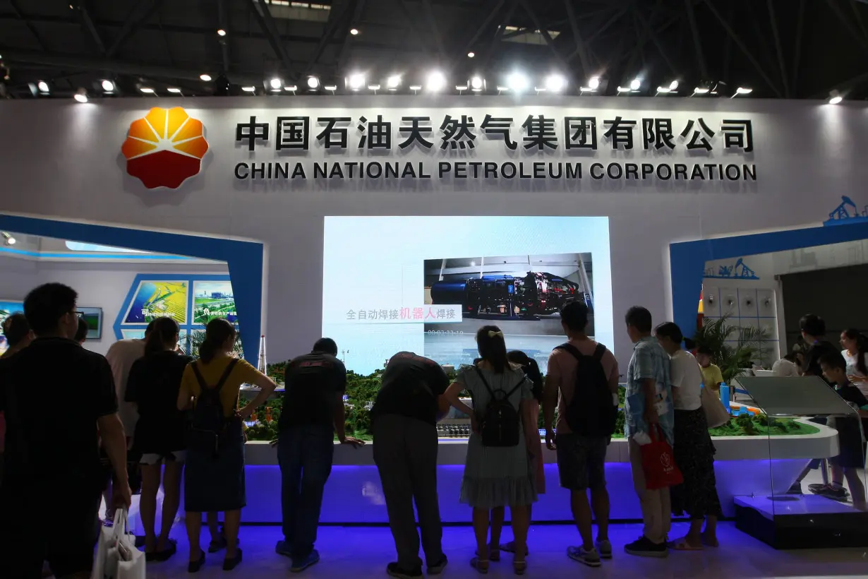 People visit a booth of China National Petroleum Corporation (CNPC) at the Smart China Expo in Chongqing