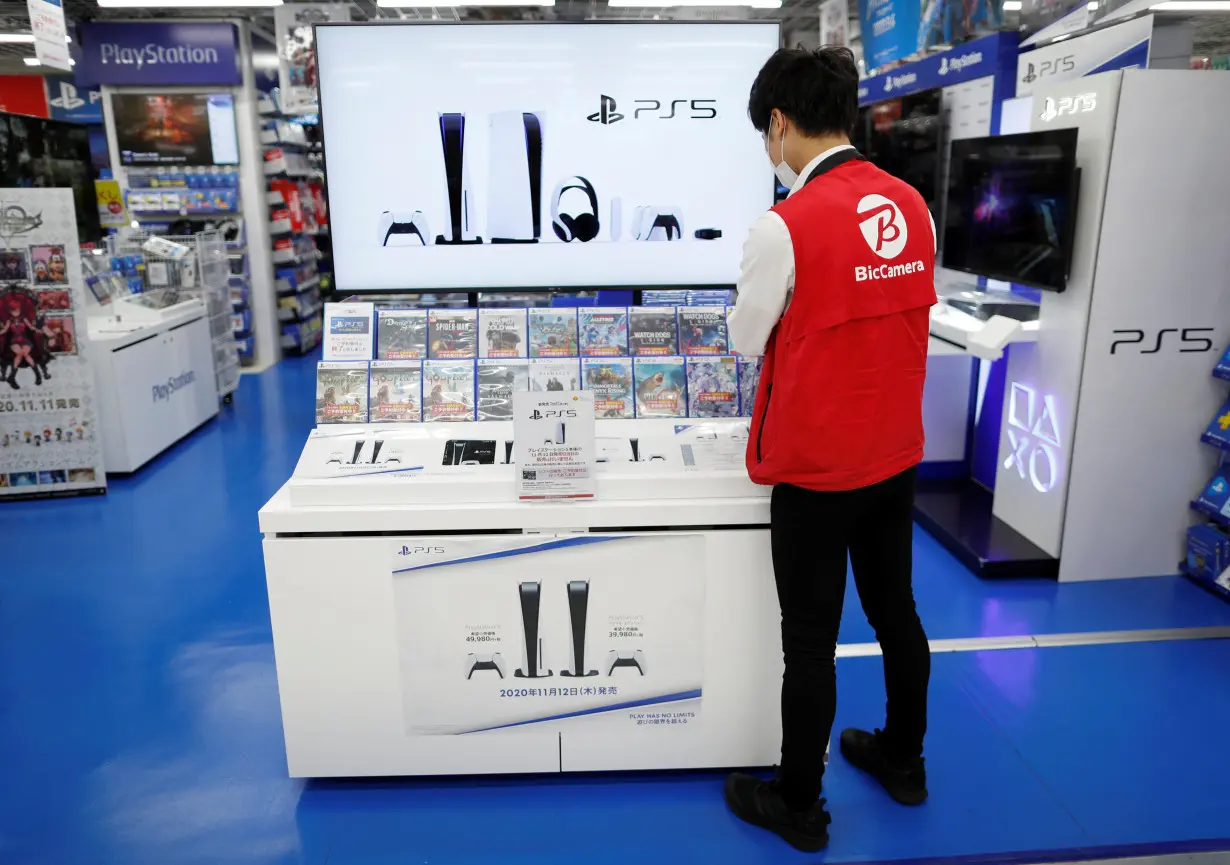 An employee works at the promotion display for the Sony PlayStation 5 game console and its gaming softwares in Tokyo