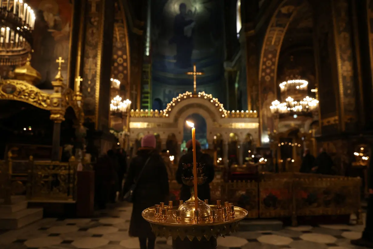 People attend early morning Ukrainian Orthodox Church services at St Volodymyr's Cathedral in Kyiv