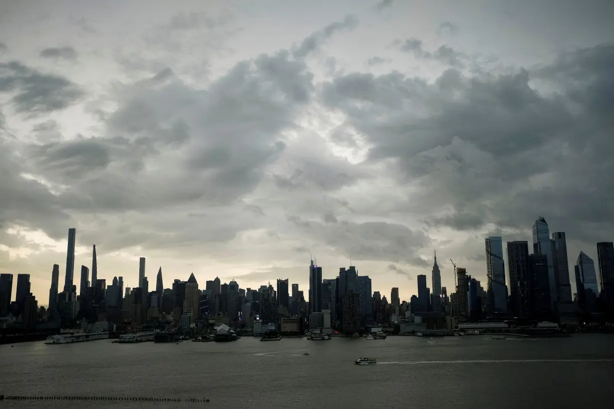 FILE PHOTO: Rain clouds cover the skyline of Manhattan at the start of the Memorial Day weekend, as seen from Weehawken, New Jersey