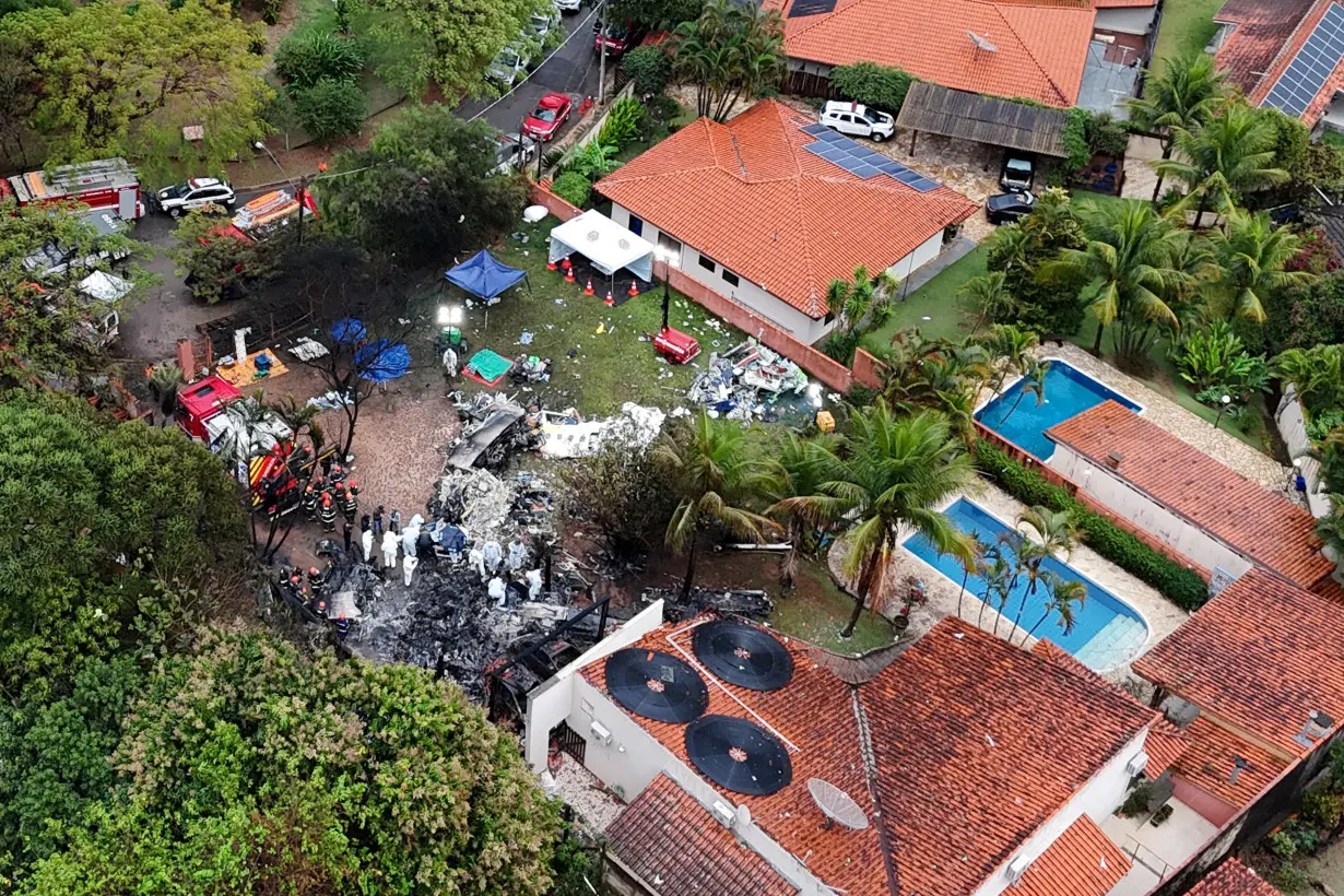 FILE PHOTO: Officials work at the site of a plane crash in Vinhedo, Sao Paulo