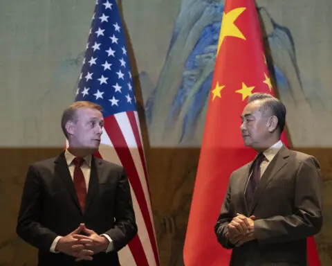 A top White House official says US and China are working to avoid conflict at talks in Beijing