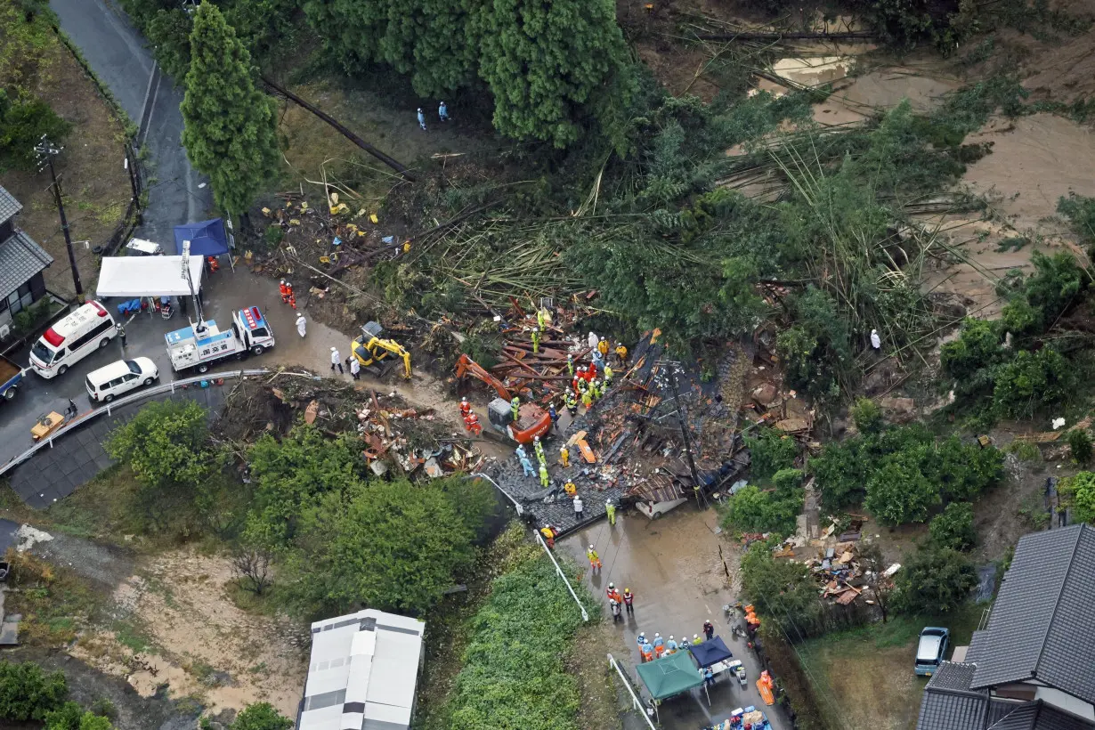 Rescue workers conduct search and rescue operation at a landslide site caused by a heavy rain due to the approach of Typhoon Shanshan in Gamagori