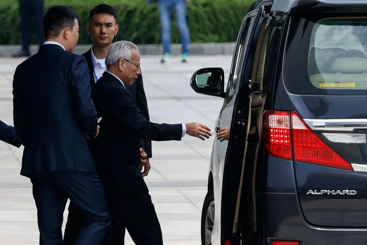 Former president of Macau's Court of Final Appeal, Sam Hou-fai, walks towards a vehicle after a press conference to announce his candidacy for Macau's sixth-term Chief Executive election, in Macau