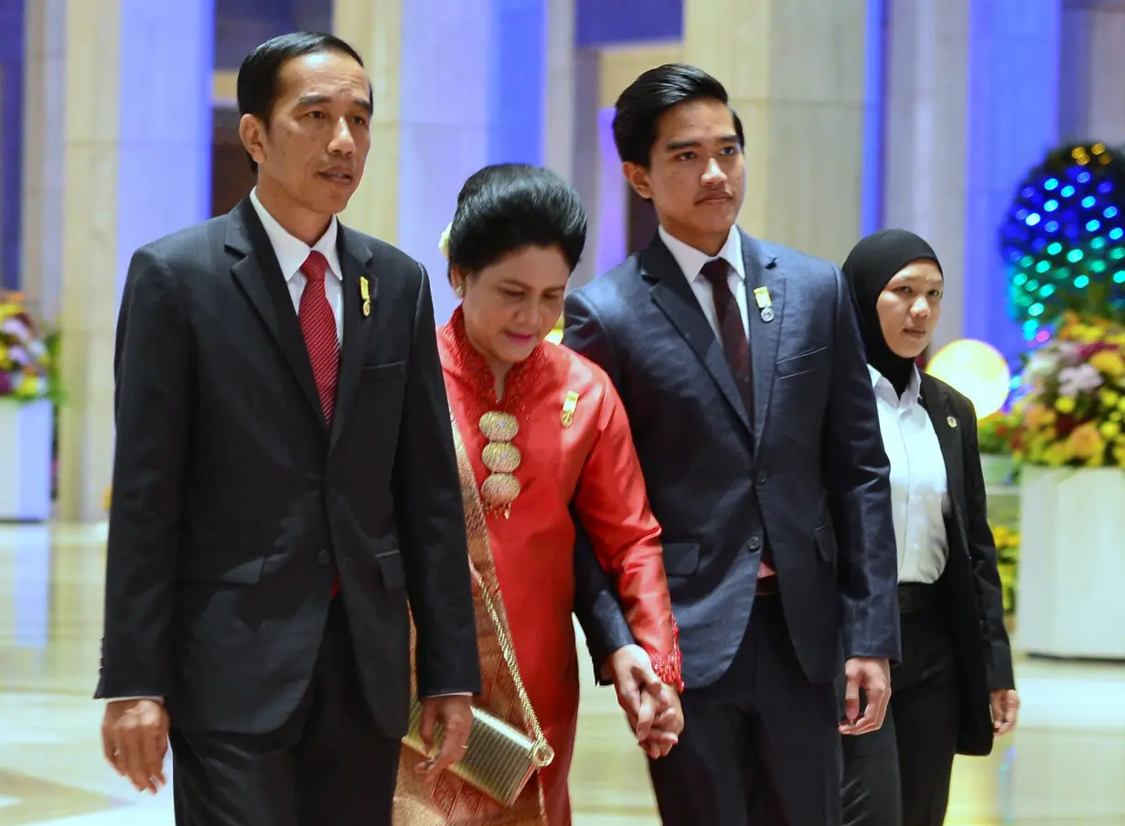 Indonesia's President Joko Widodo, his wife Iriana and son Kaesang Pangarep arrive for the royal banquet of Brunei's Sultan Hassanal Bolkiah at Nurul Iman Palace in Bandar Seri Begawan, Brunei Bandar Seri Begawan