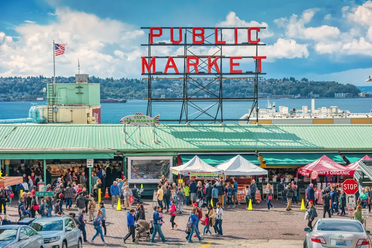 People walk at the Pike Place Market in Seattle. Washington State's largest city is the No. 1 Labor Day destination, according to AAA.