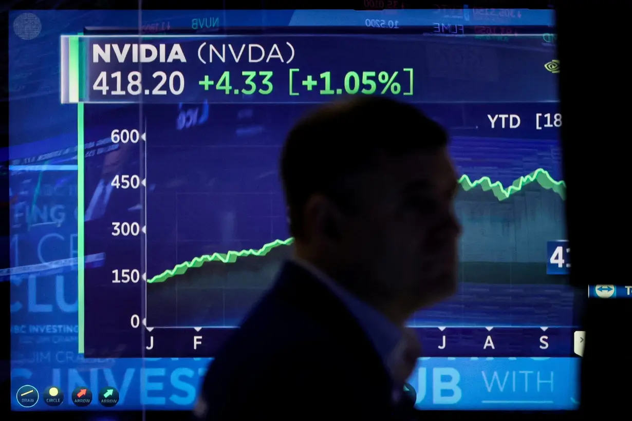 Traders work on the floor of the NYSE in New York