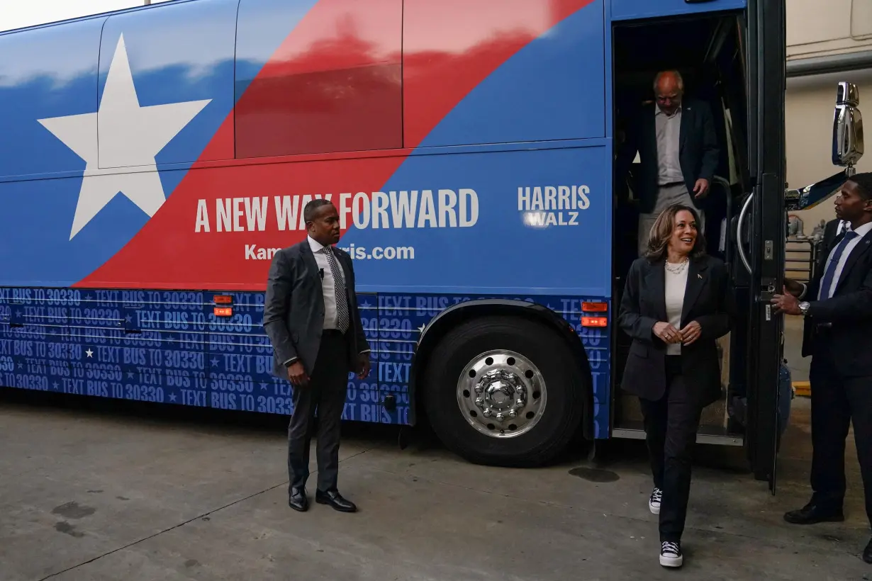 Harris and Walz step off a campaign bus after multiple stops, in Savannah