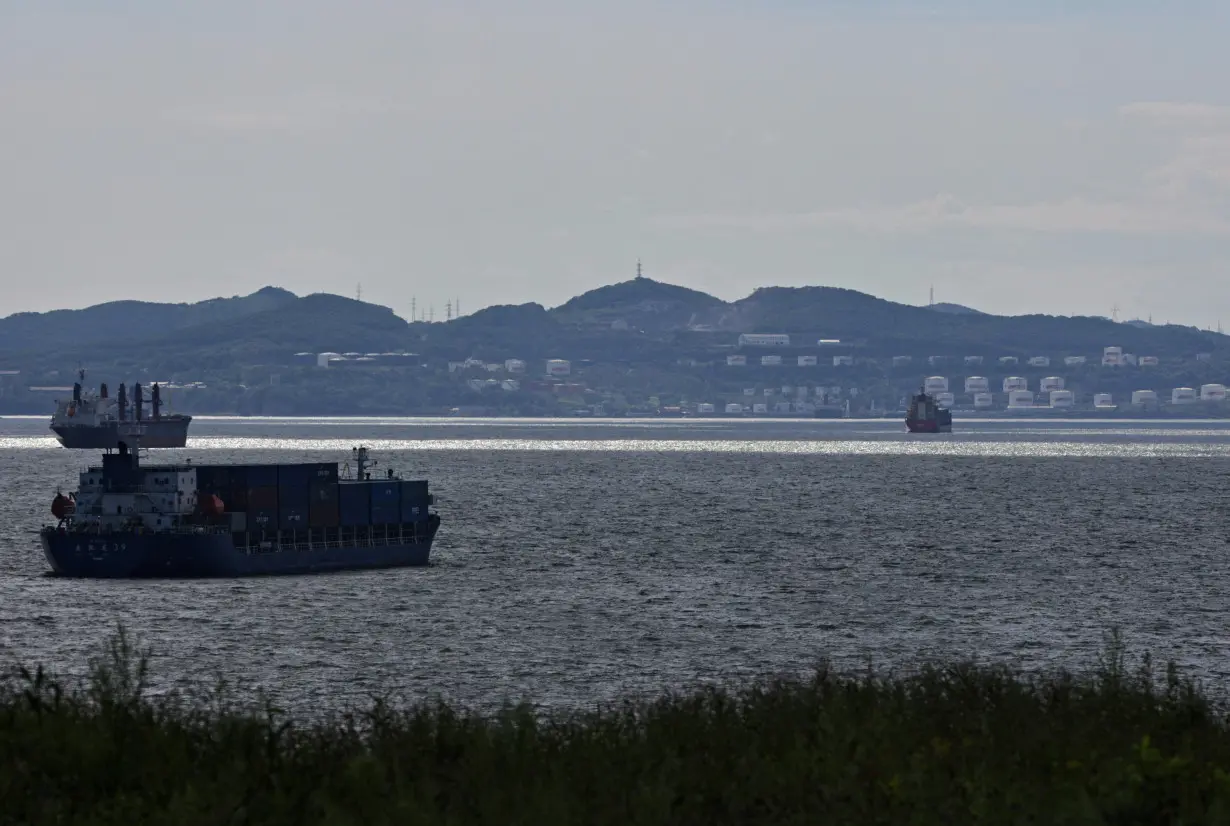 A container ship sails along Nakhodka Bay near the oil terminal in the port city of Nakhodka