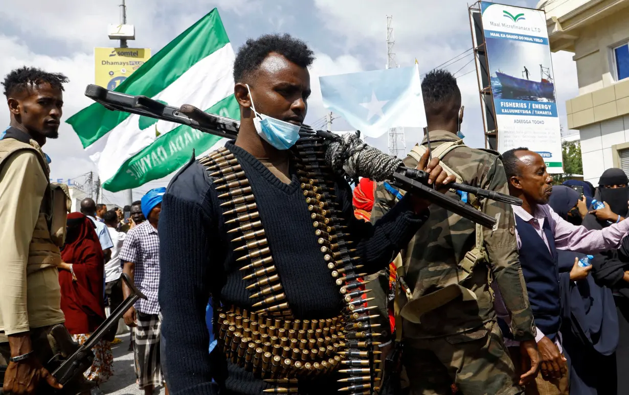 FILE PHOTO: A Somali police officers stands guard during a march against the Ethiopia-Somaliland port deal along KM4 street in Mogadishu