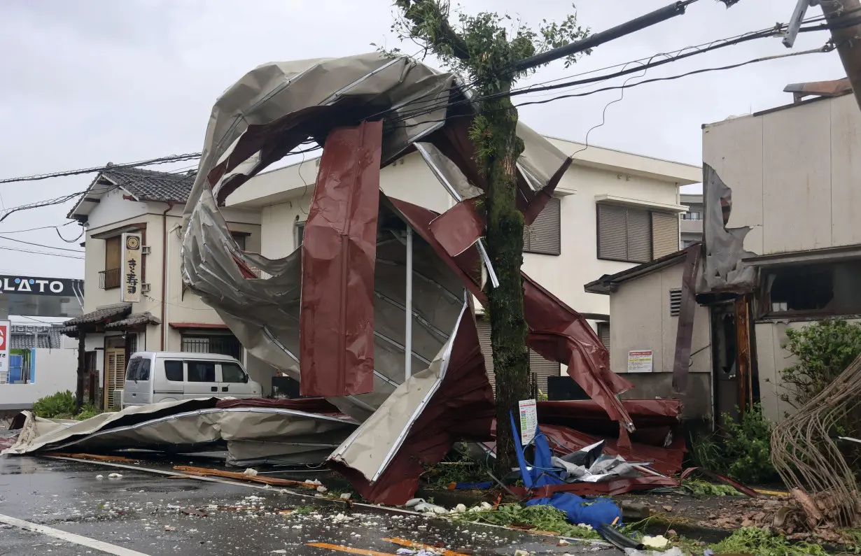 An object blown by strong winds caused by Typhoon Shanshan is stranded on a power line in Miyazaki, southwestern Japan