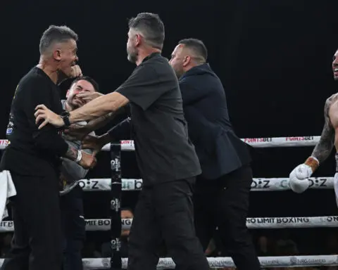 Boxer's brother punches rival's trainer in chaotic post-fight melee