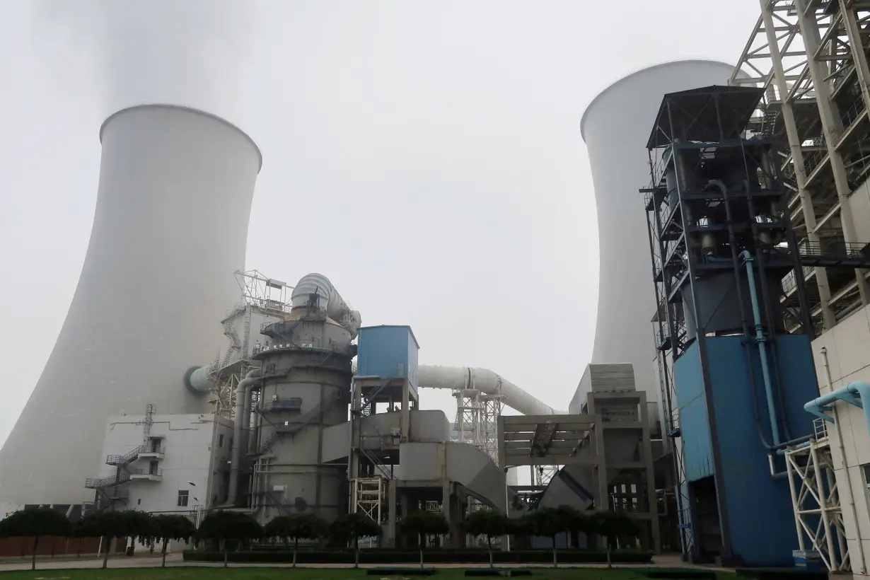 FILE PHOTO: Water vapour rises from a cooling tower of a China Energy ultra-low emission coal-fired power plant during a media tour, in Sanhe