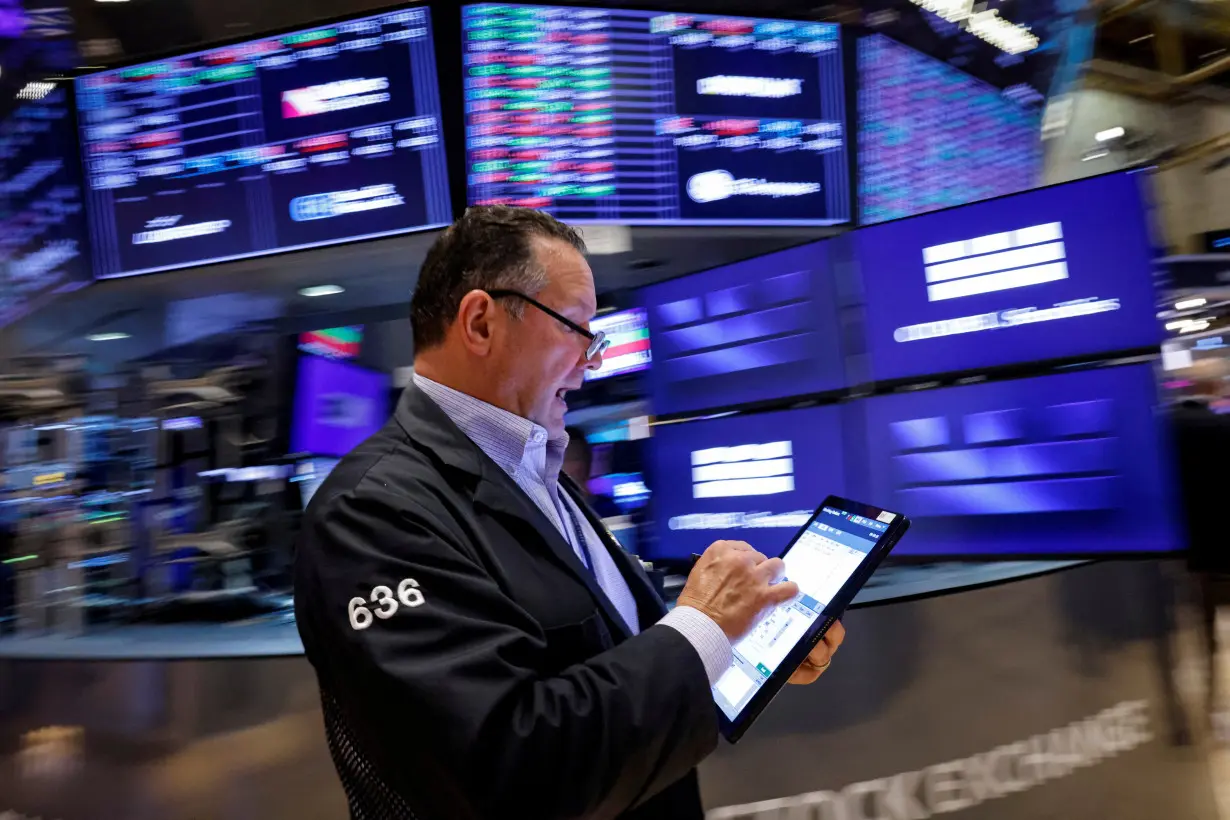 Traders work on the floor of the NYSE in New York