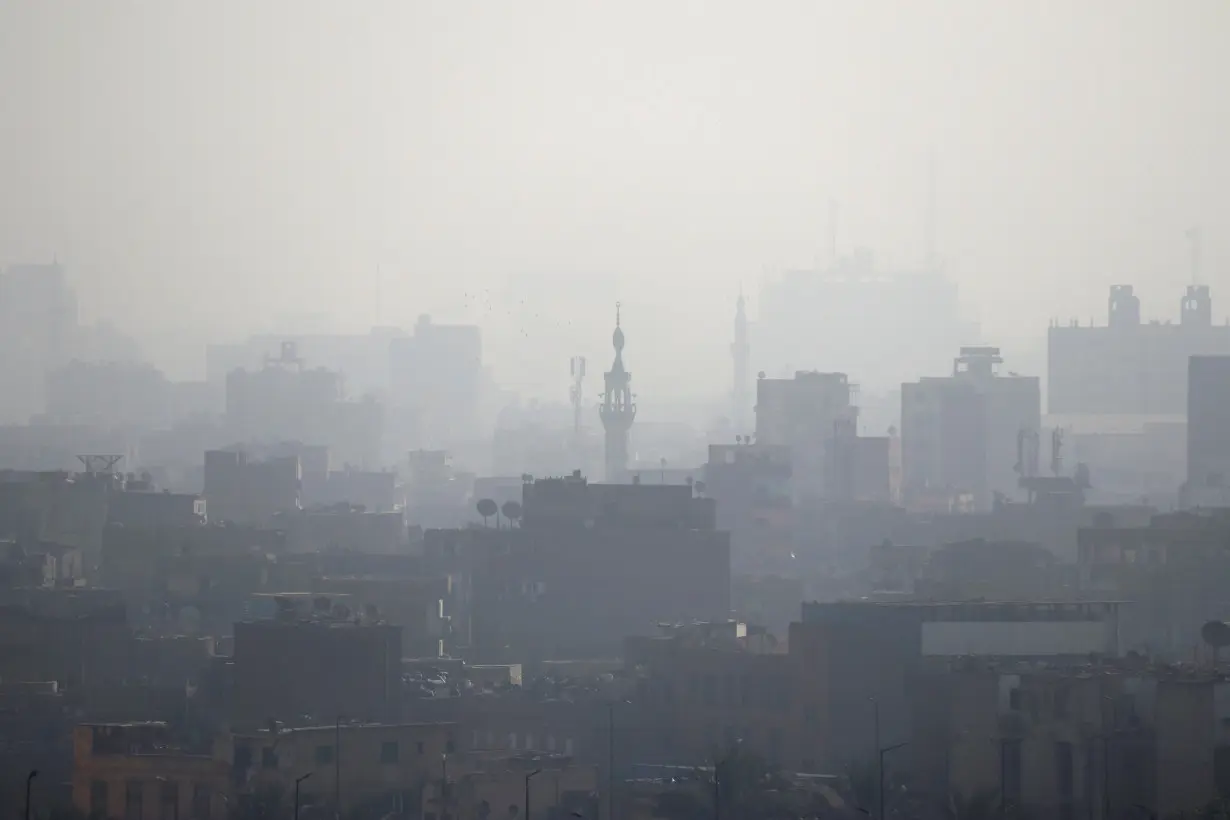 FILE PHOTO: A minaret is seen through early morning haze on the skyline of Cairo