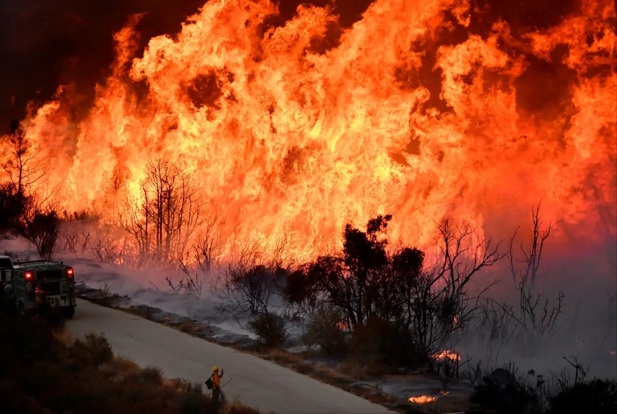 Fire fighters attack the Thomas Fire's north flank with backfires as they continue to fight a massive wildfire north of Los Angeles, near Ojai , California