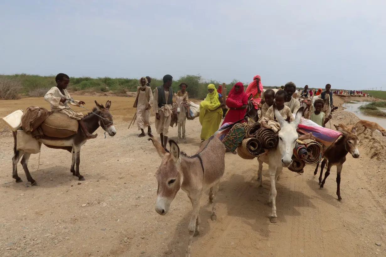 Evacuees move their belongings on donkeys, following devastating floods, in Tokar, Red Sea State, Sudan