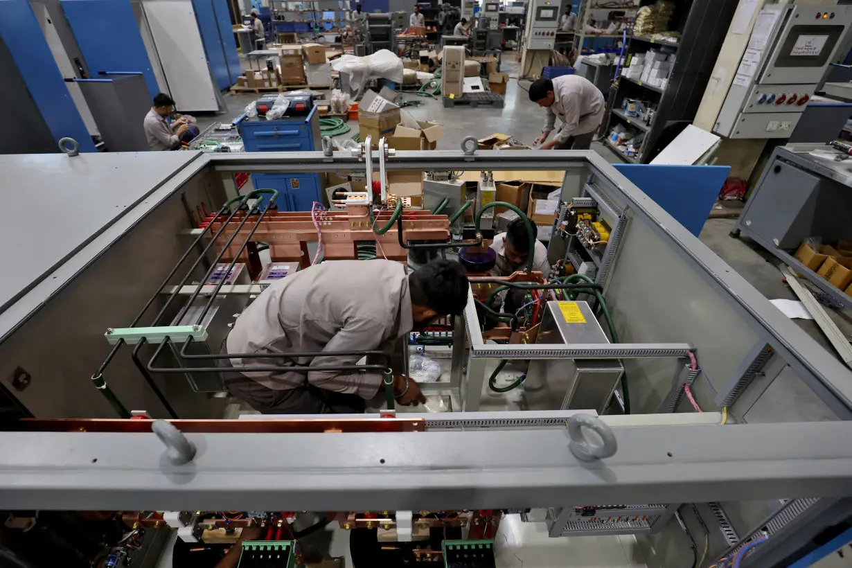 FILE PHOTO: Employees assemble an electric transformer inside a manufacturing unit of Electrotherm (India) Private Limited at Sanand GIDC (Gujarat Industrial Development Corporation), on the outskirts of Ahmedabad