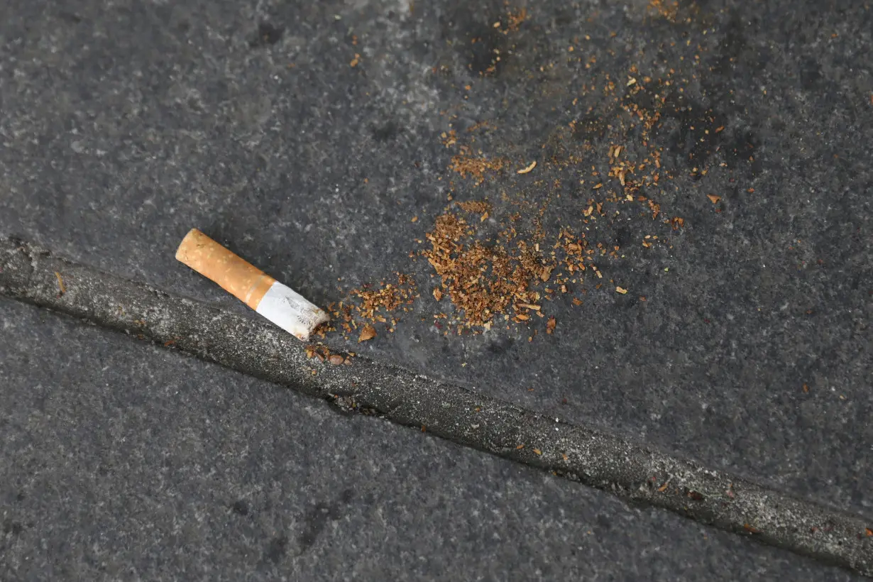 A cigarette butt lies on a street in New York