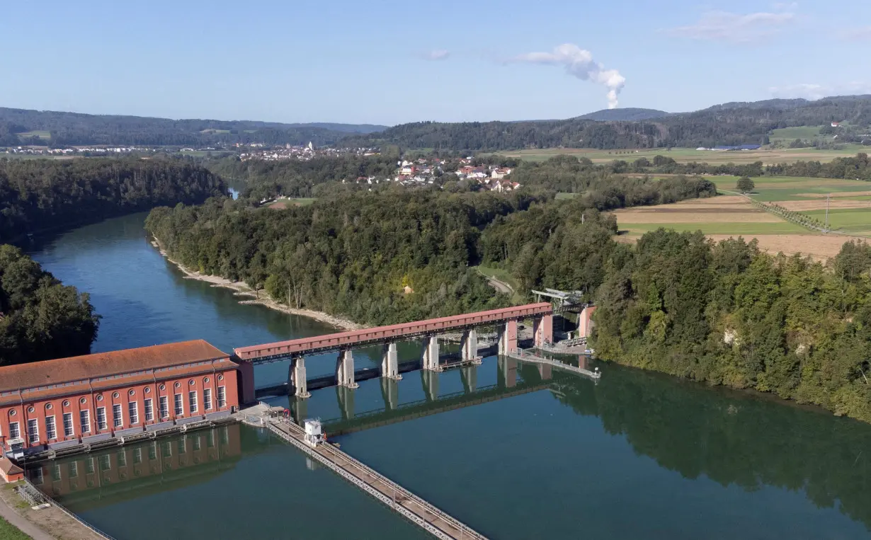 FILE PHOTO: Steam rises from nuclear power plant KKW Leibstadt behind the hydropower plant Eglisau in Rheinsfelden, Switzerland