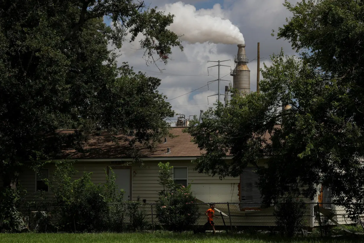 FILE PHOTO: Child runs through the backyard of a home in the Manchester neighbourhood of Houston