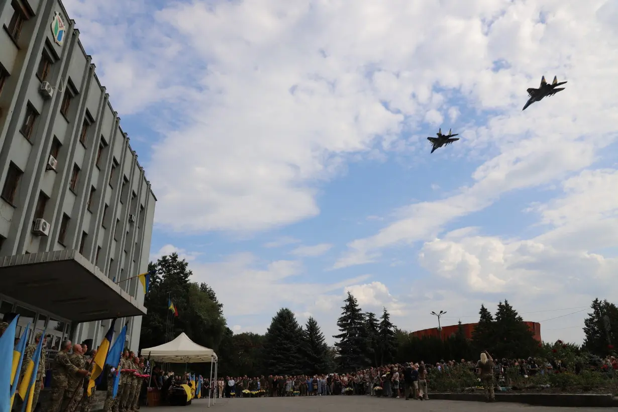 A fighter jet flies during a funeral of Ukrainian military fighter pilot Mes who died in a combat mission