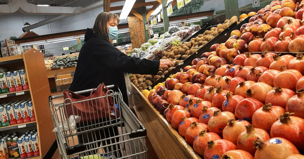 FILE PHOTO: A person shops for vegetables at a supermarket in Ottawa