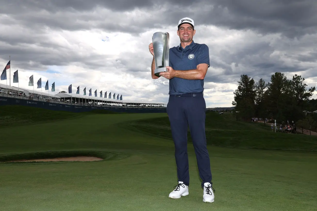 Keegan Bradley poses with the BMW Championship trophy after victory in Castle Rock, Colorado.