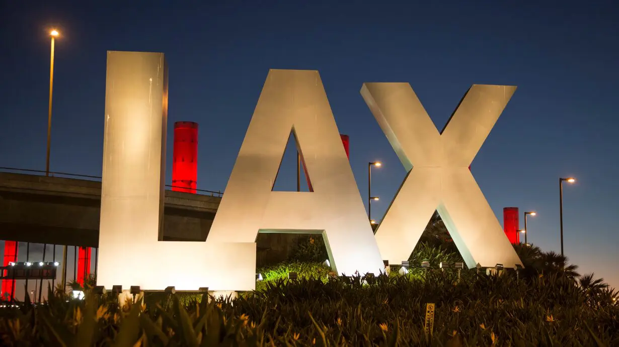 Shirtless man is arrested after running across tarmac at LAX