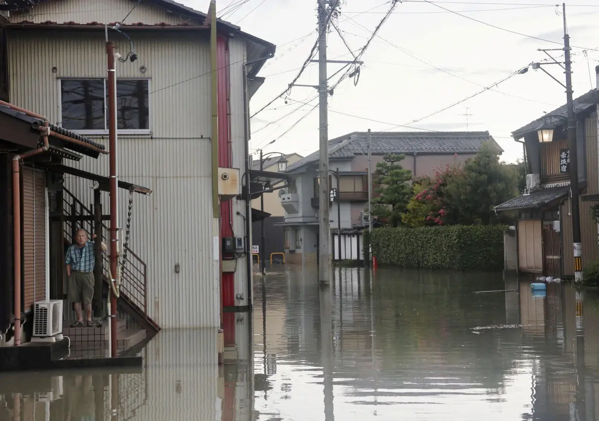 FILE PHOTO: A man stands at a residential area affected by the flooding of the Kuise River caused by Typhoon Shanshan in Ogaki