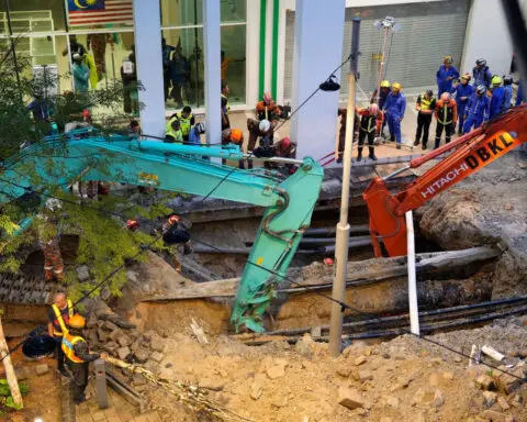 Malaysia halts rescue operation for woman who plunged into sinkhole
