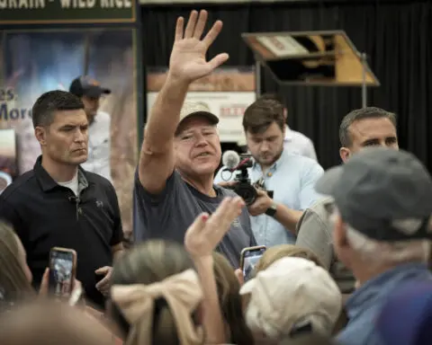 It's a pork chop on a stick and a vanilla shake for Tim Walz at the Minnesota State Fair