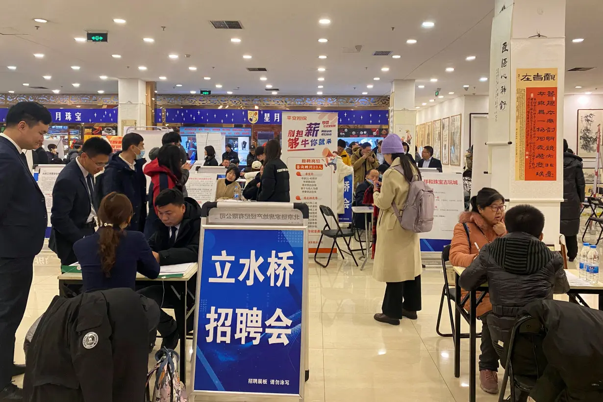 People attend a job fair in Beijing