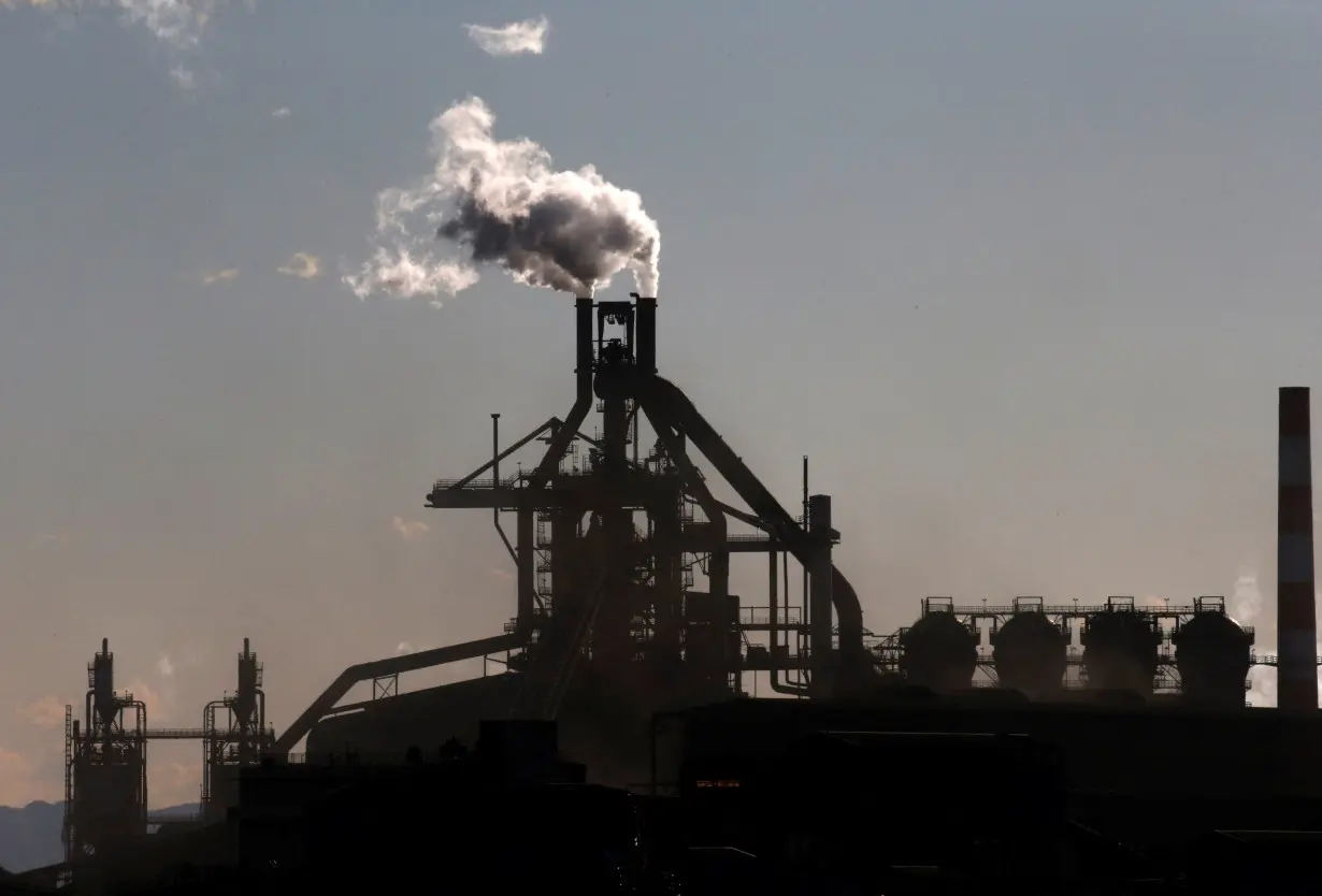 FILE PHOTO: Chimneys of a steel factory are pictured at an industrial area in Kawasaki