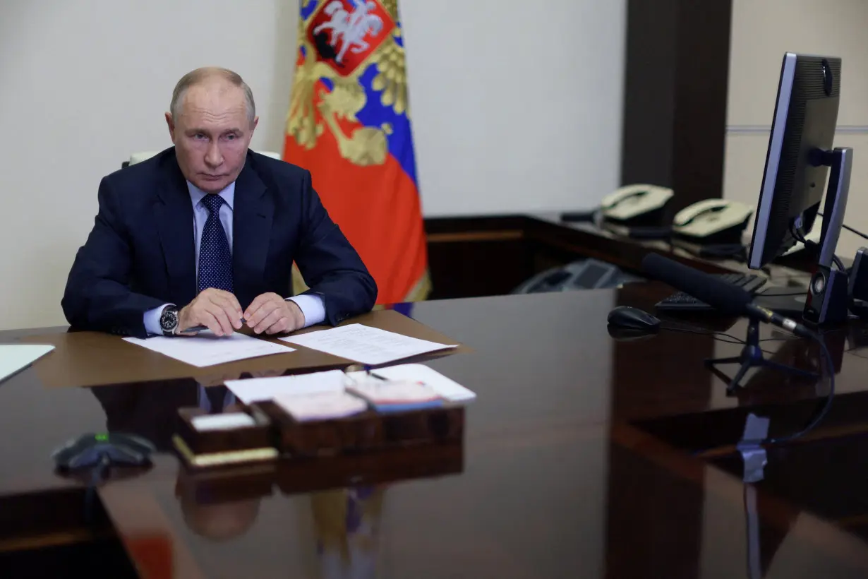 FILE PHOTO: Russian President Putin chairs a meeting outside Moscow