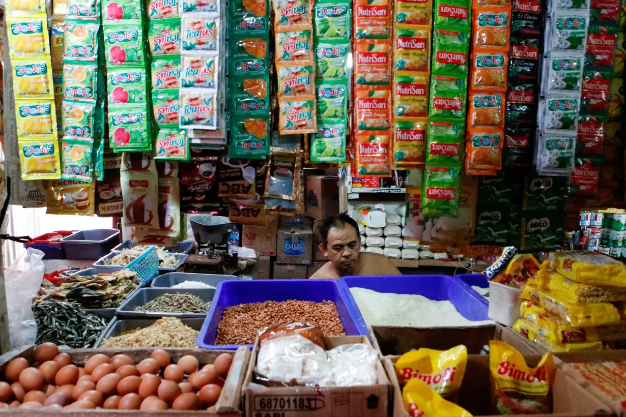 A vendor waits for customers at a traditional market in Jakarta