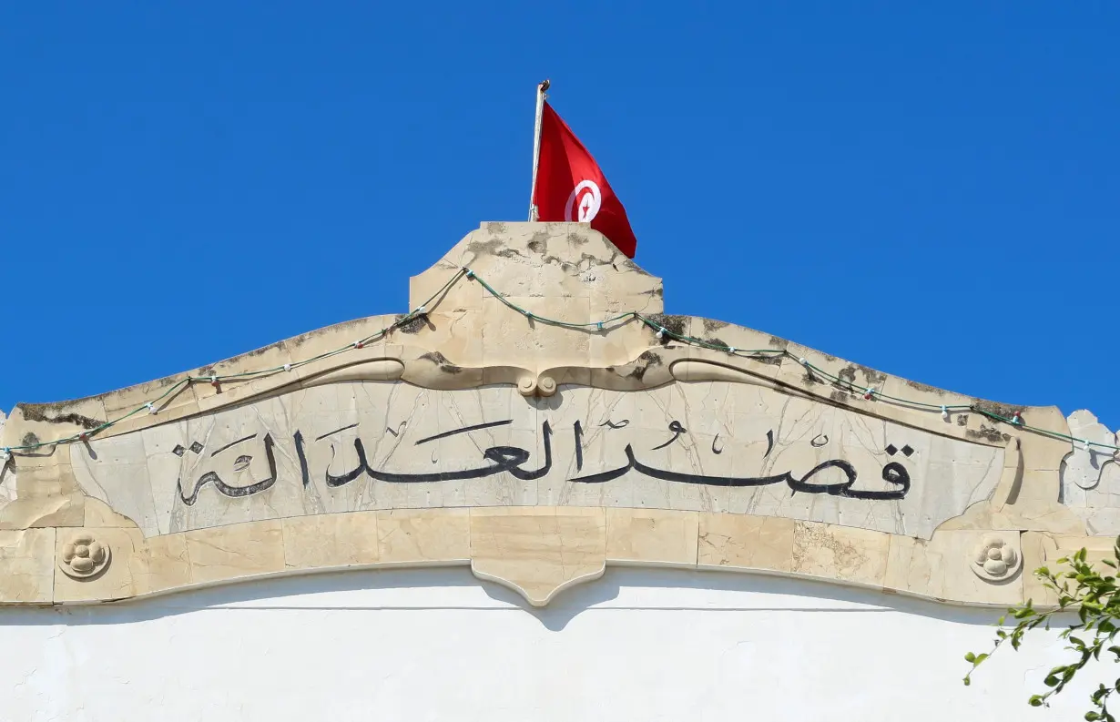 A Tunisian flag flutters atop of the Palace of Justice building in Tunis