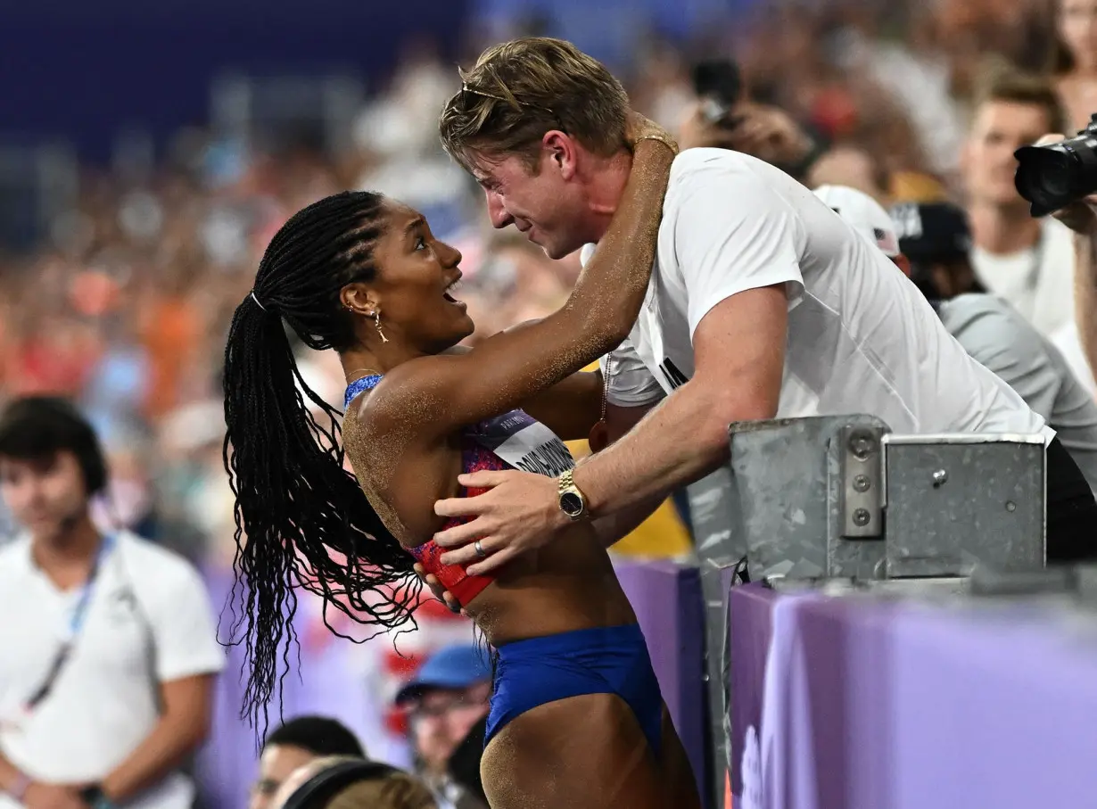 Tara Davis-Woodhall celebrates with her husband Hunter Woodhall after winning gold.