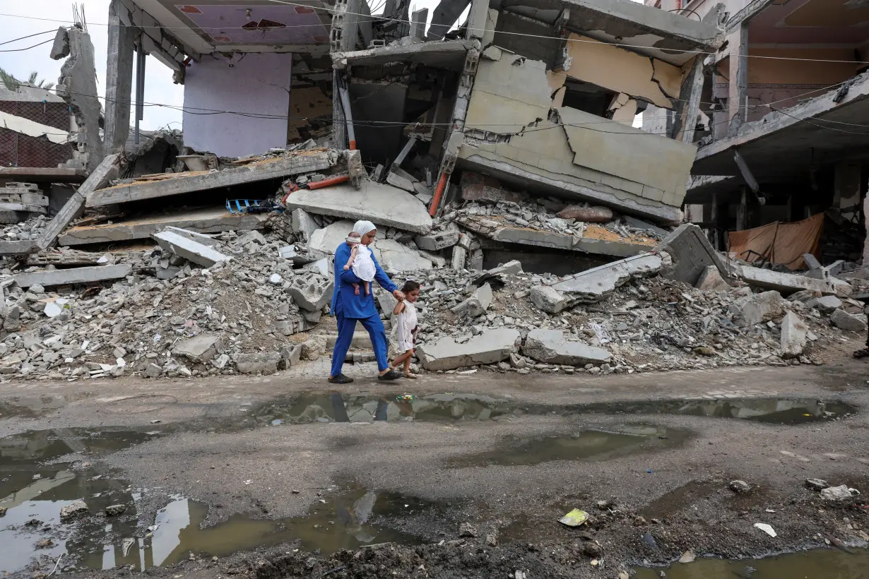 Gazan mother treads through rubble-strewn streets to vaccinate her children against polio