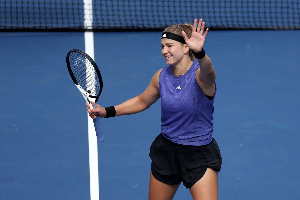 Muchová celebrates after defeating Paolini.